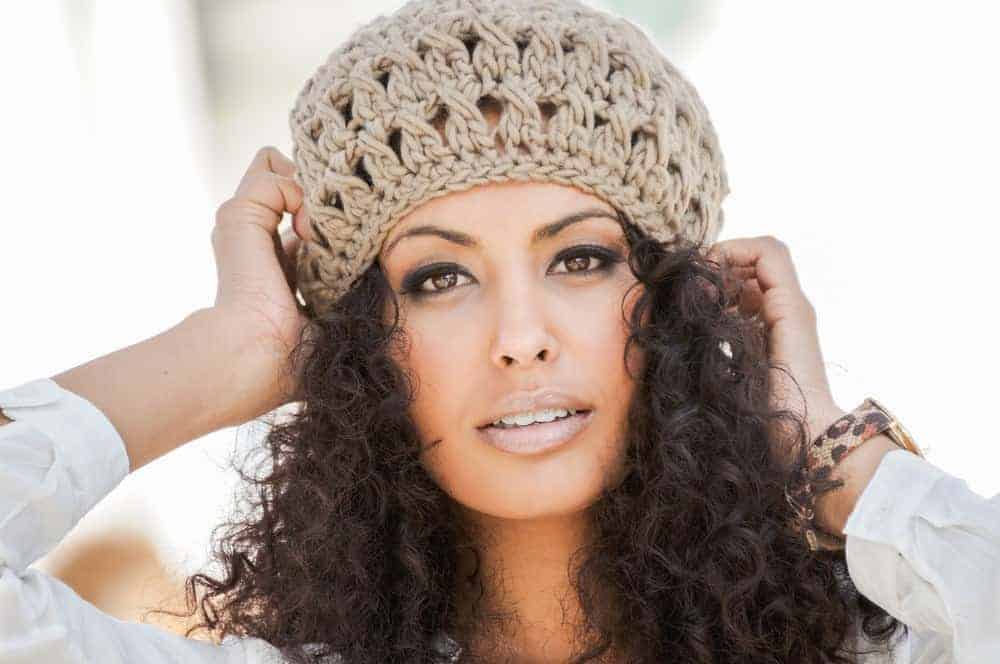 How to Use Castor Oil for Curly Hair Growth & Thicker Curls 1 Cute African American female with natural curls styled with tea tree oil, pure castor oil, and fresh ginger juice.