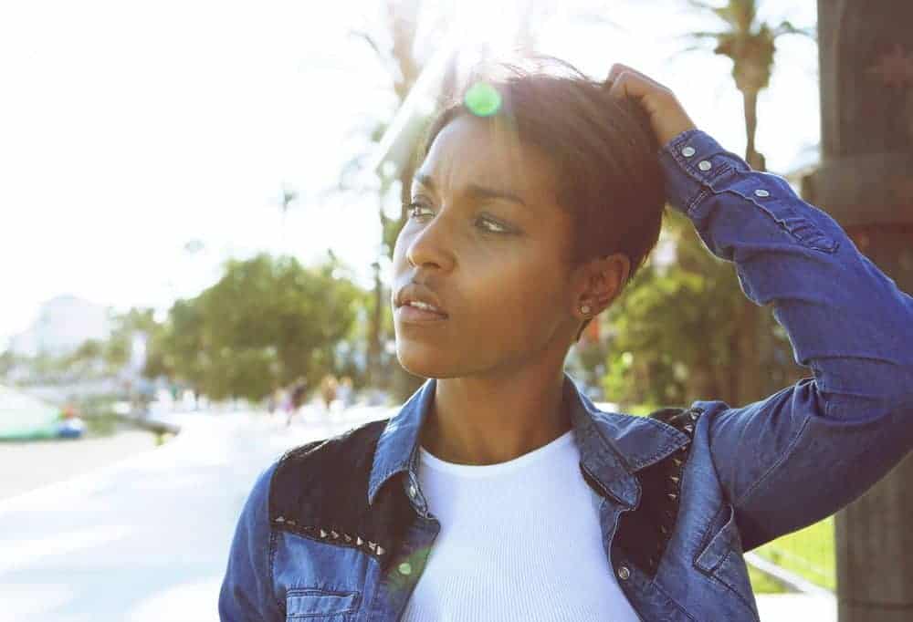 Hair Relaxers: How to Relax Curly Hair without Significant Damage 1 Cute young African American female with frizzy hair after heat styling her tight curls with natural oils.