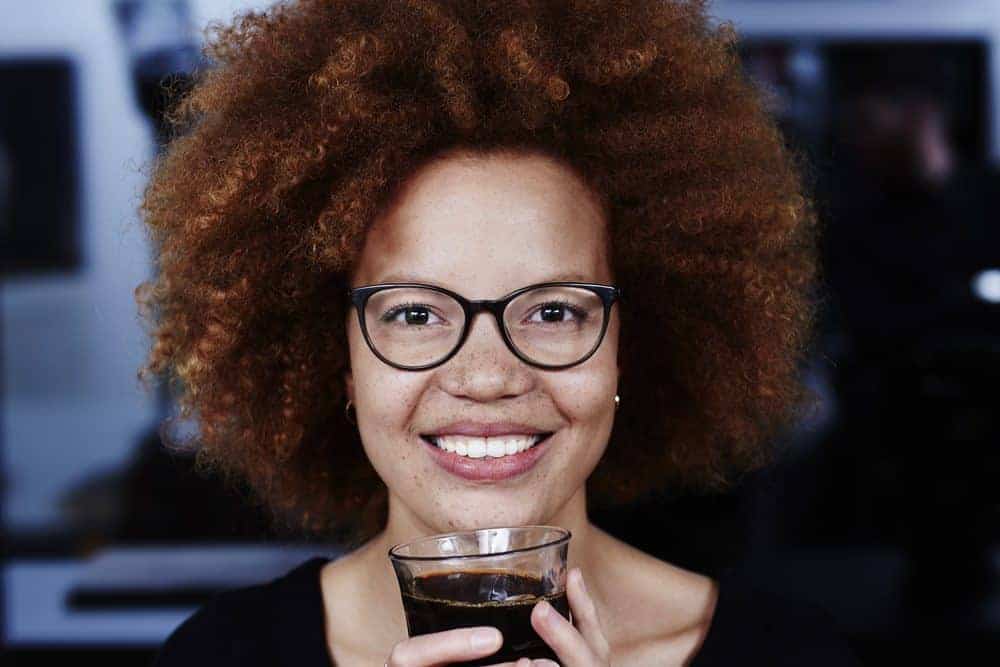 African American female with natural beauty wearing her thick hair in a wash n' go afro style hairdo.