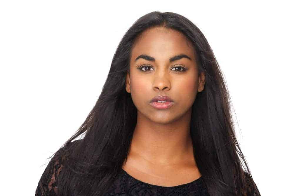 Black girl with light brown skin wearing human hair extensions