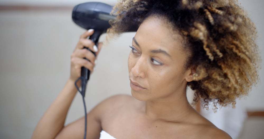 Women with 3c hair using blow dryer