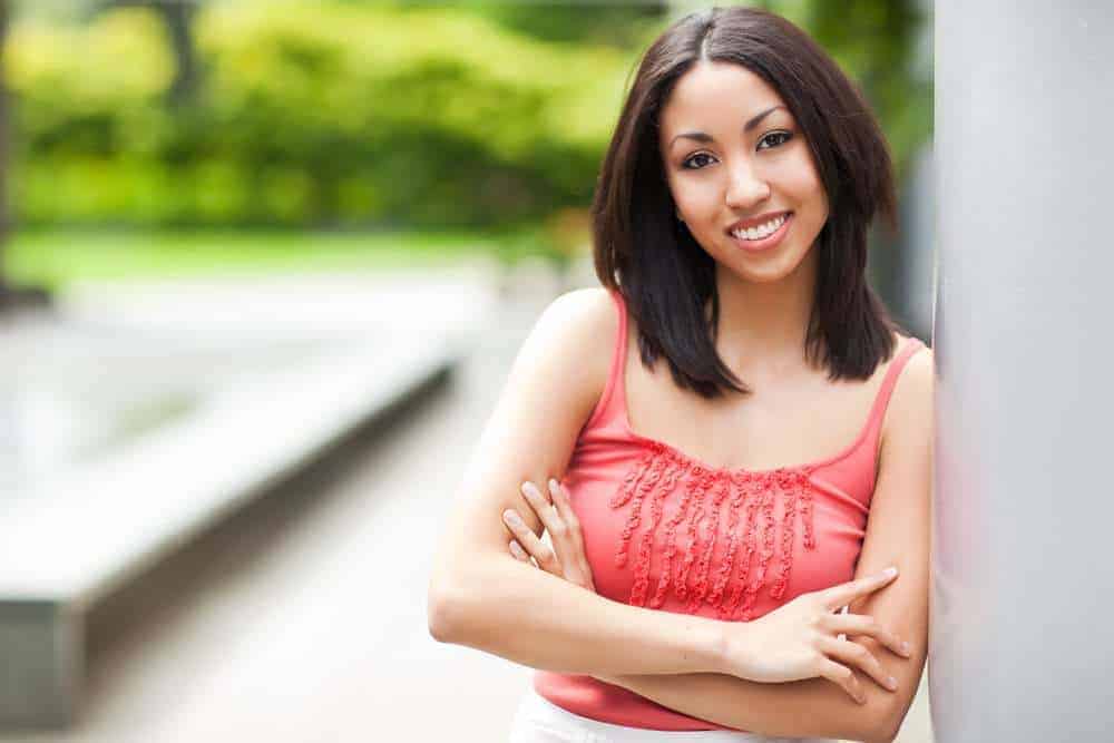 Beautiful mixed race woman with a red shirts and straight type 1 hair