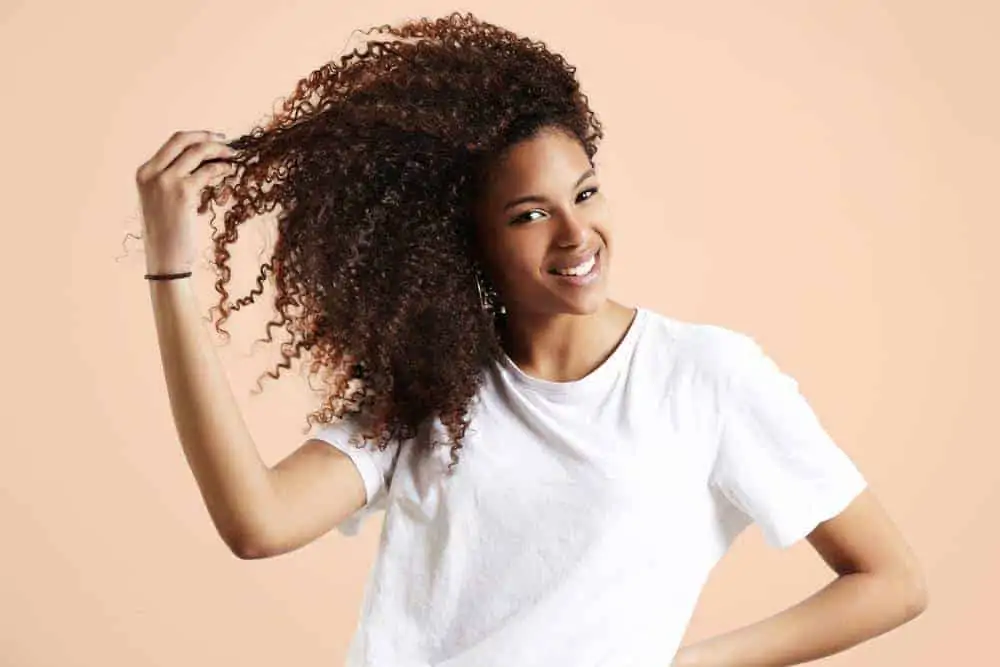 Cute female with curly hair wearing a white t-shirt