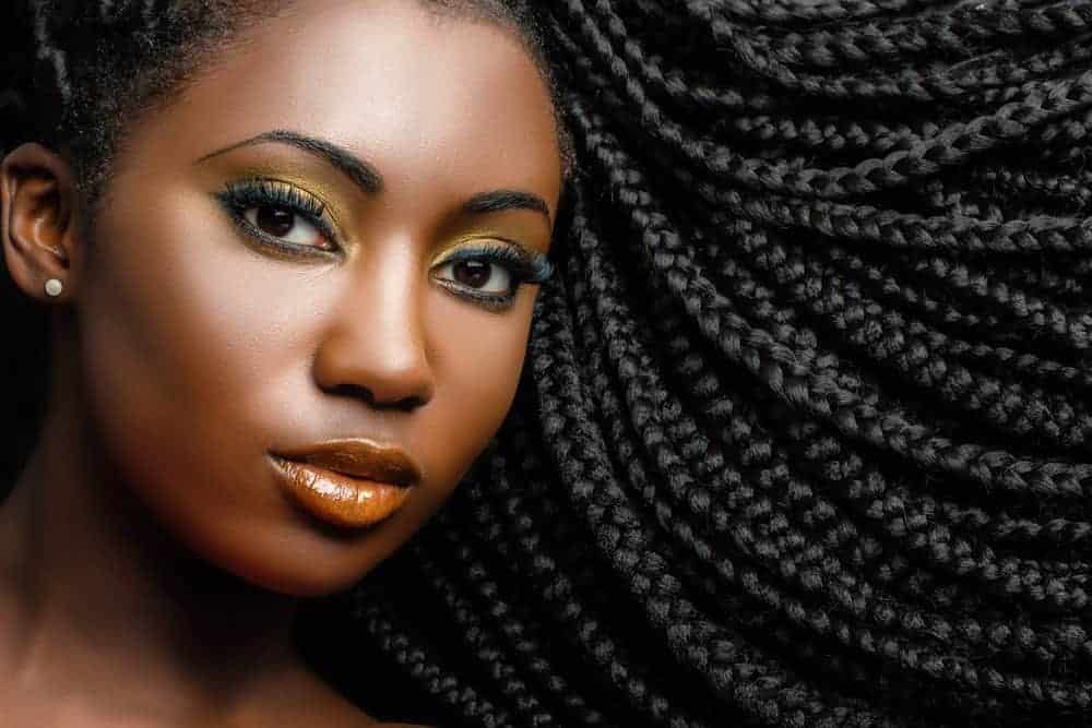 Black girl wearing human hair box braids with hair left out.