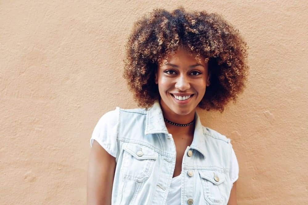 how does shampoo workA cute African American female showing off her natural curls after using an organic shampoo and conditioner.