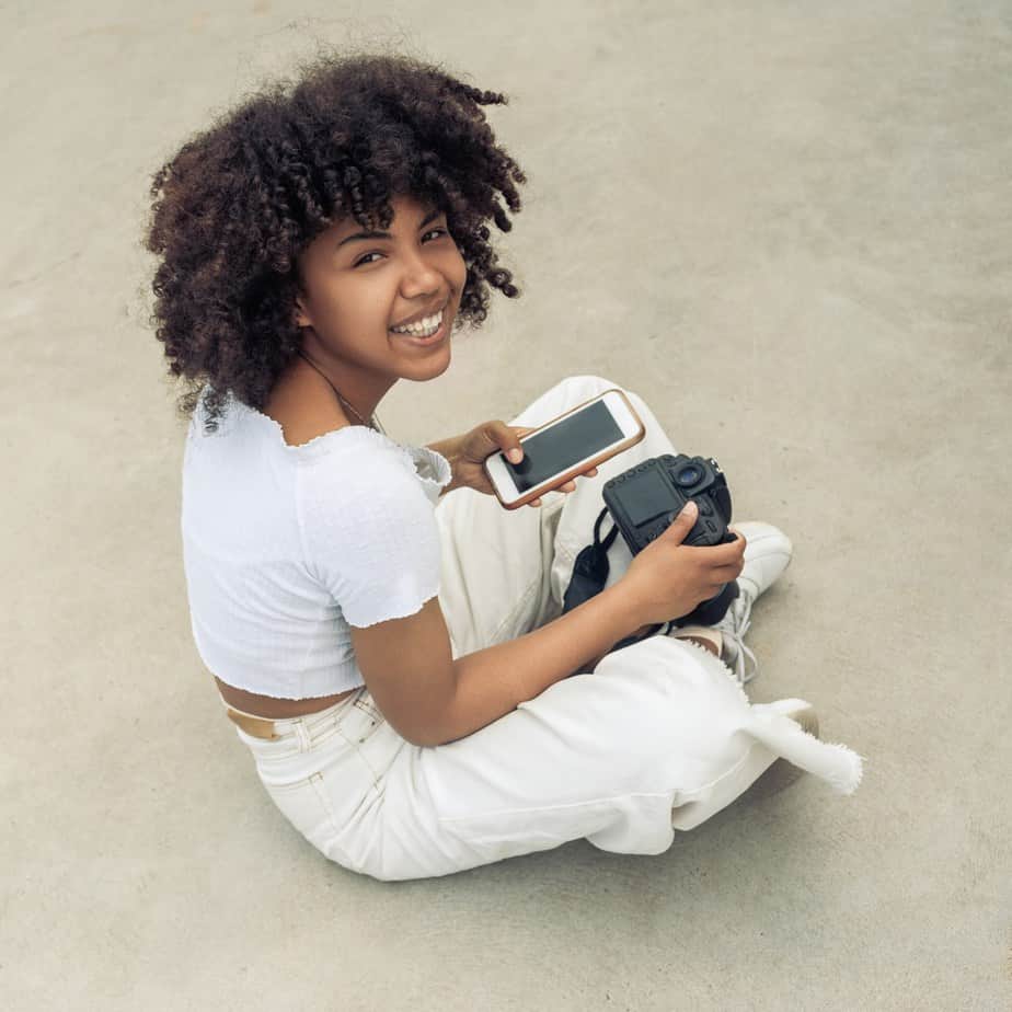 Cute black woman with individual curls created with rods and sleeping with a silk scarf and a leave-in conditioner.