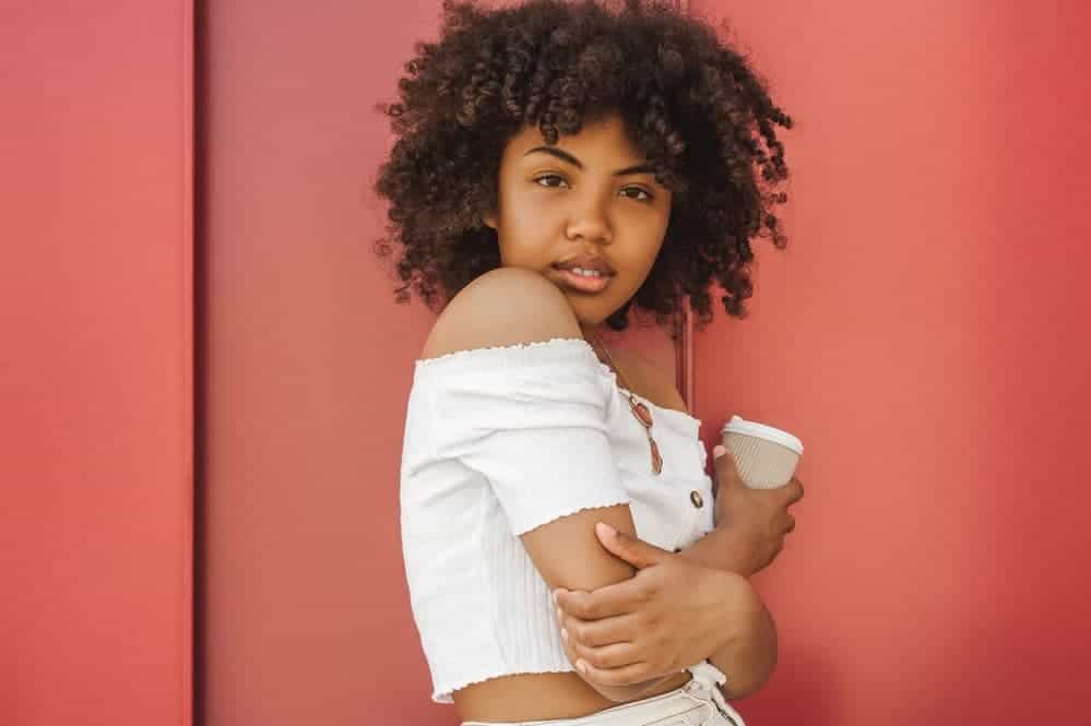 Cute African American female with freshly washed hair wearing a flexirod set on natural hair.