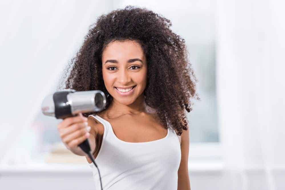 The Curly Girl Method for Curly, Wavy, Straight & Color Treated Hair 5 African American women avoiding a hairdryer because she is starting the Curly Girl Method