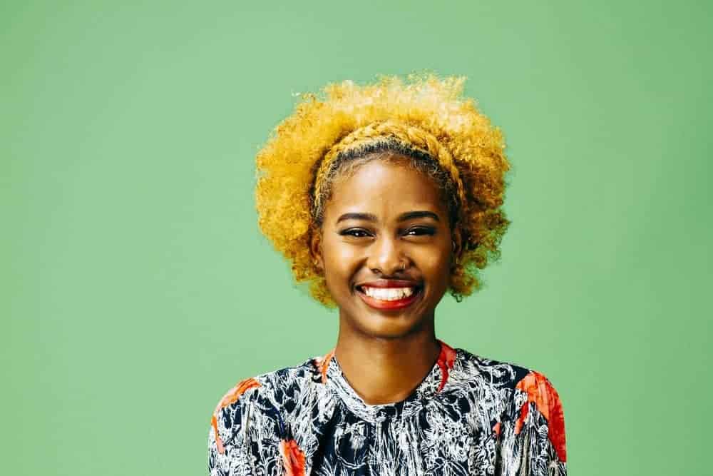 very happy black girl with a halo braid across the front of her hair