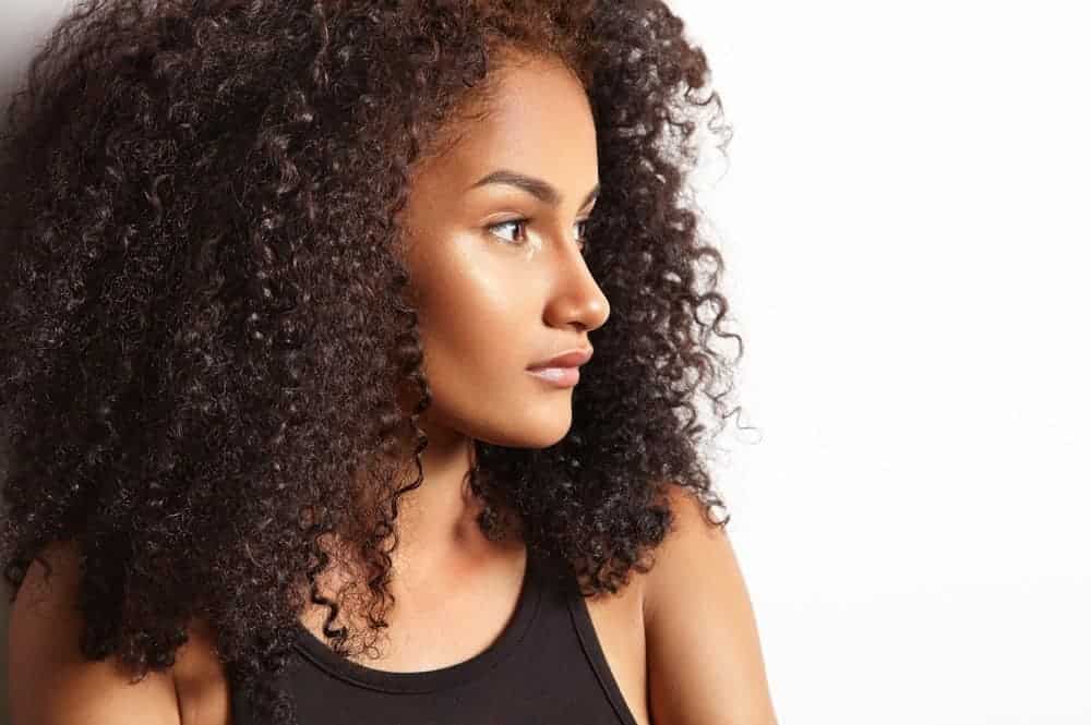 A beautiful black female that uses clarifying shampoos within her natural hair regimen to remove excess oil.