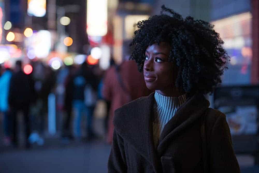 The Best Essential Oils for Hair Growth and Thickness (Our Favorites & DIY Tips) 10 Pretty black women with curly hair walking through a city street at night.
