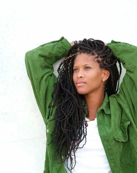 black women wearing goddess braids locs and green shirt