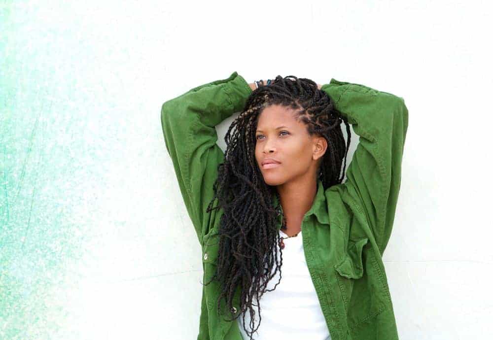 black women wearing goddess braids locs and green shirt