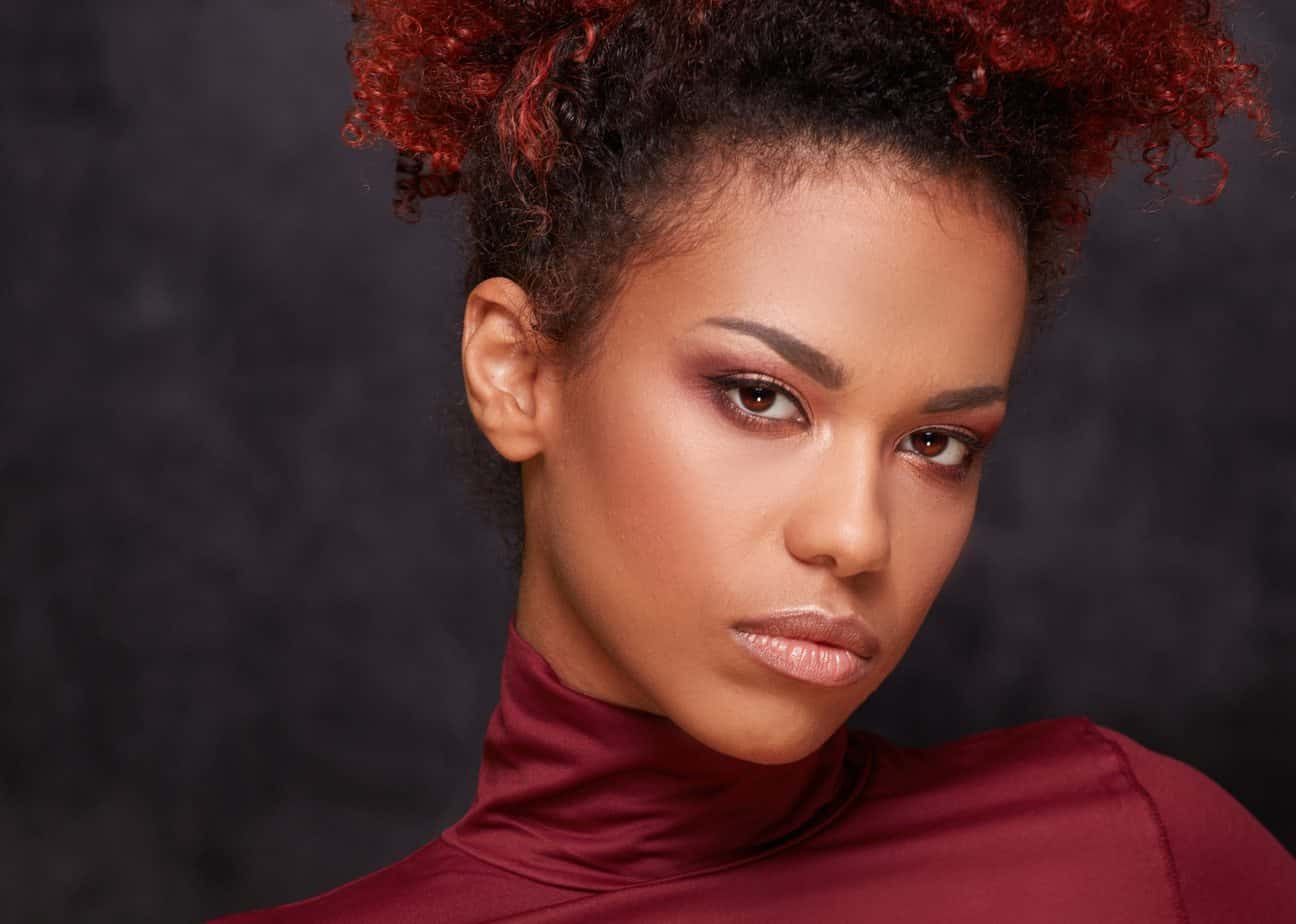 African American female with fine hair after using a red and black box hair dye mixture to create a two-toned shade.