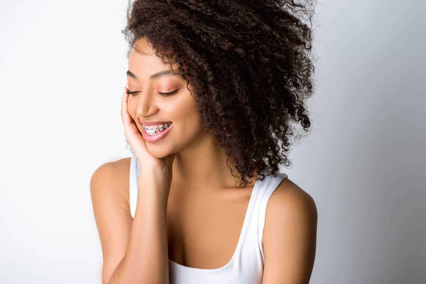 The Best Way to Use Rosemary Oil for Hair Growth 7 African American female admiring her hair after using rosemary oil