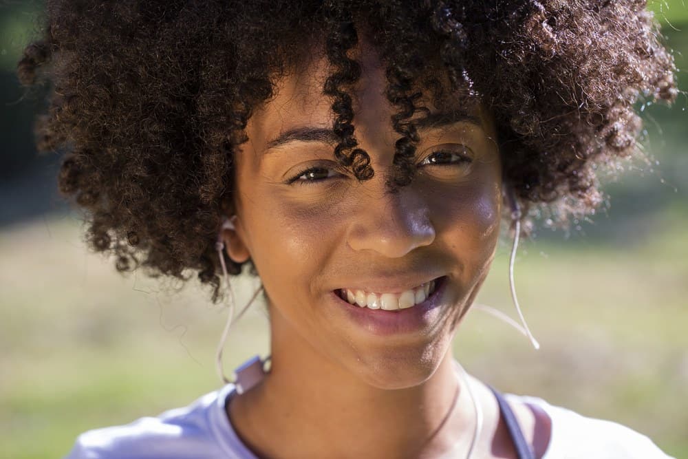 Close up portrait of an attractive mixed African Brazilian woman smiling outdoors.