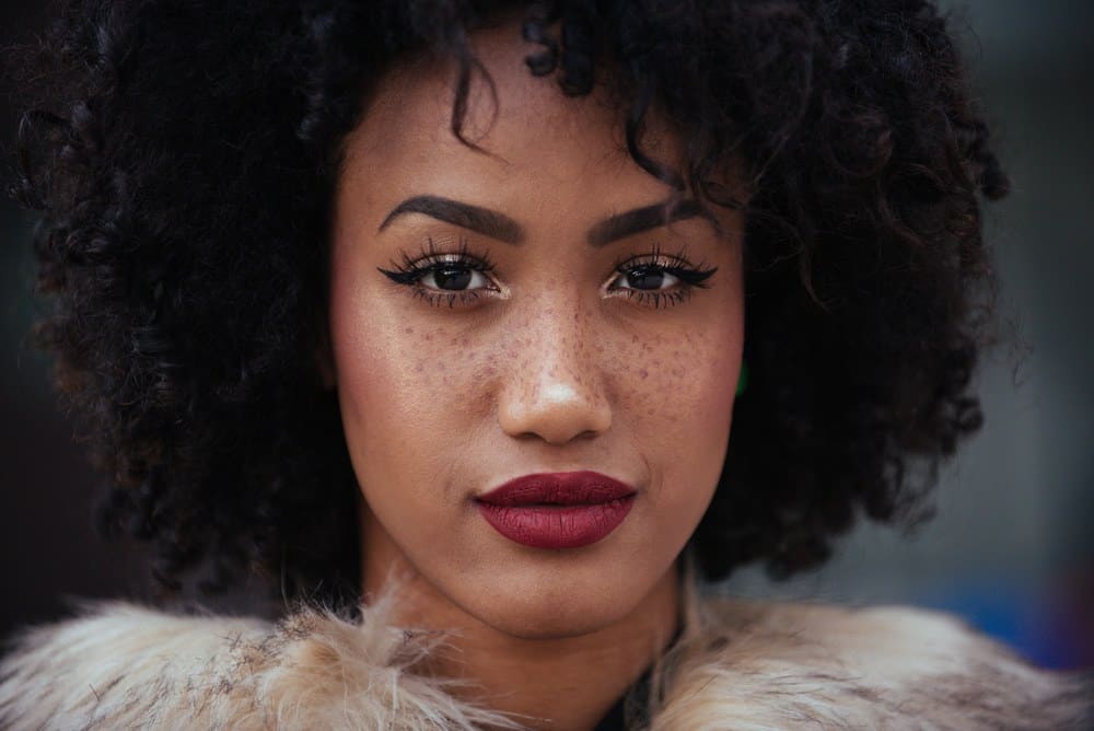 Cute black girl with natural curls styled with a few drops of cedarwood essential oil and sweet almond oil.