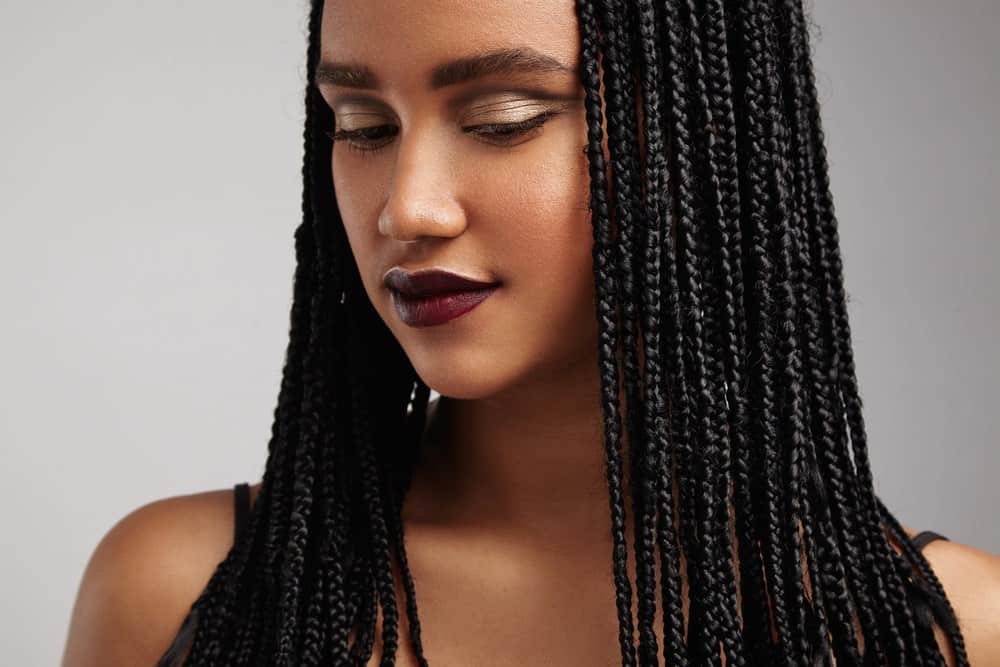 Closeup portrait of black woman with braids.