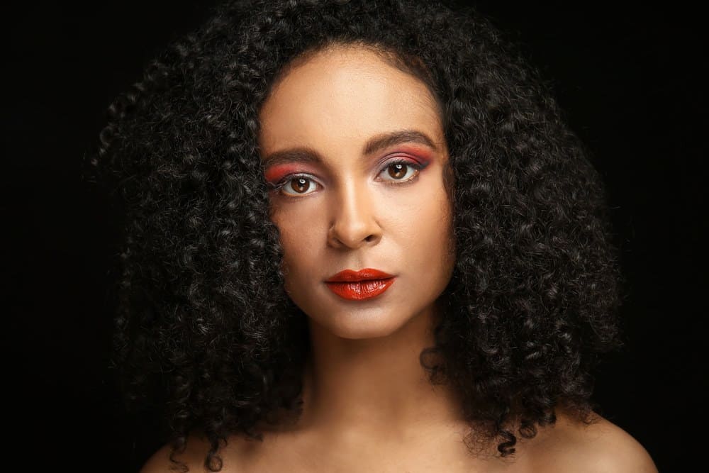 A lady with coils after using baobab fruit powder and oil extracts for the polyunsaturated fatty acids and linoleic acid.