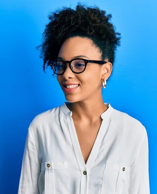 Cute young African American female after using a carrier oil (jojoba oil) and shea butter oil to boost hair growth.