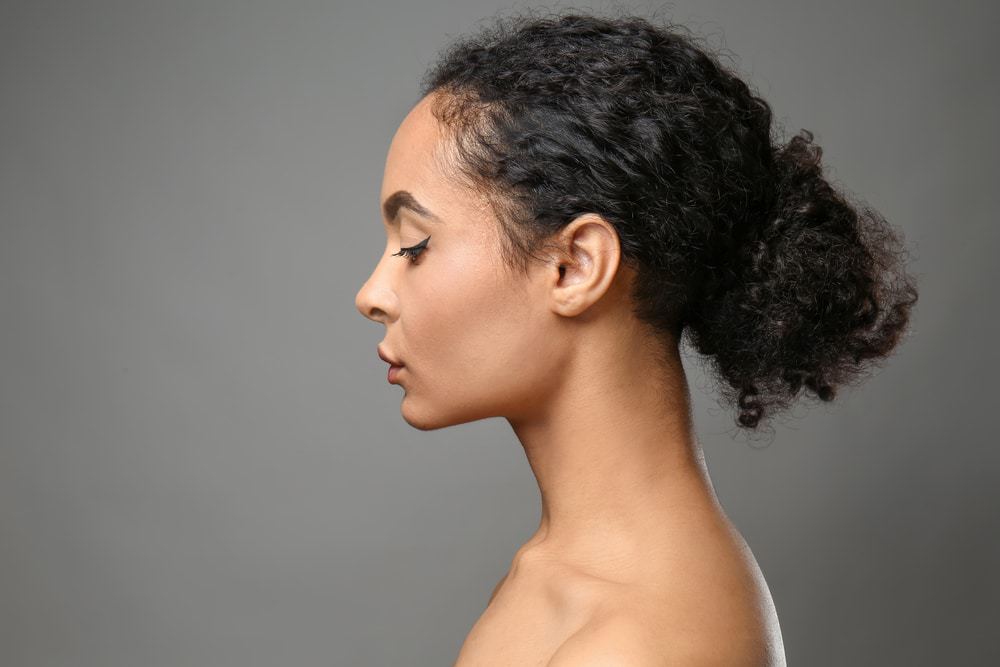 A beautiful African-American woman showcasing her 3A natural hair.