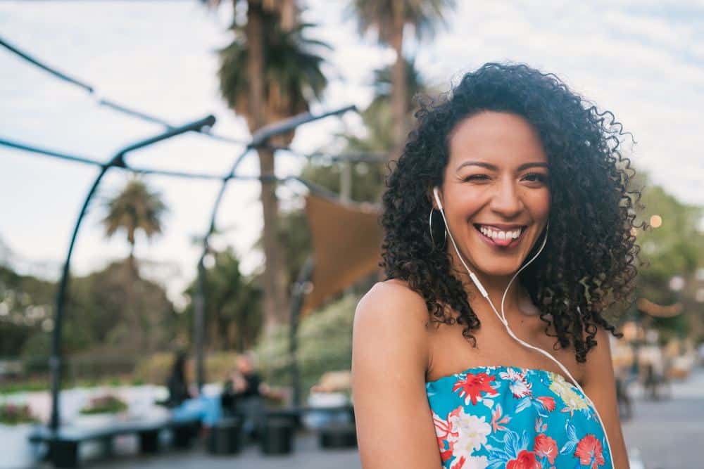 A cute African American female that used extra virgin olive oil to treat acute skin infections and scalp inflammation.