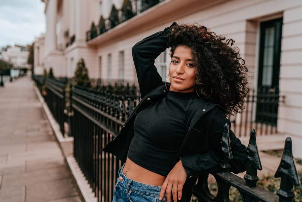 Cute mixed-race female after using sunflower oils to reduce hair breakage and mitigate an itchy scalp.