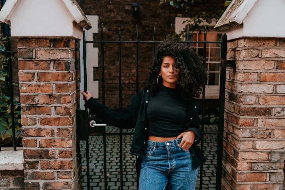 A female with natural curls styled with a DIY mix of sunflower seeds, jojoba oil, and other oils for future hair growth.