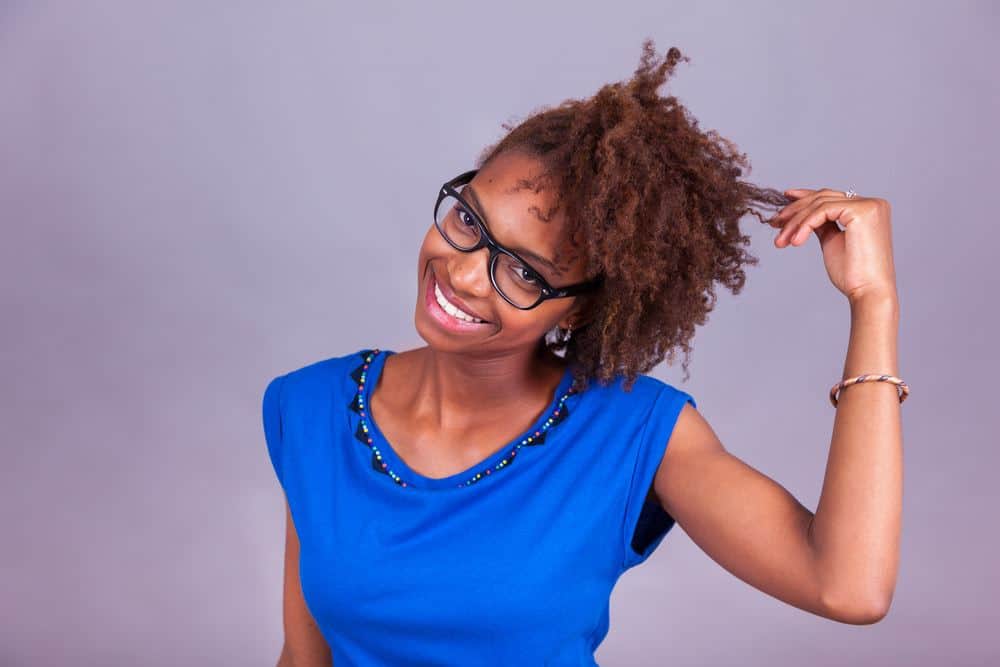 Hair Myths and Facts That Aren't Posted on Every Natural Hair Blog 3 Cute black girl with 4c curly hair wearing a blue short, black reading glasses and orange and blue bracelet.