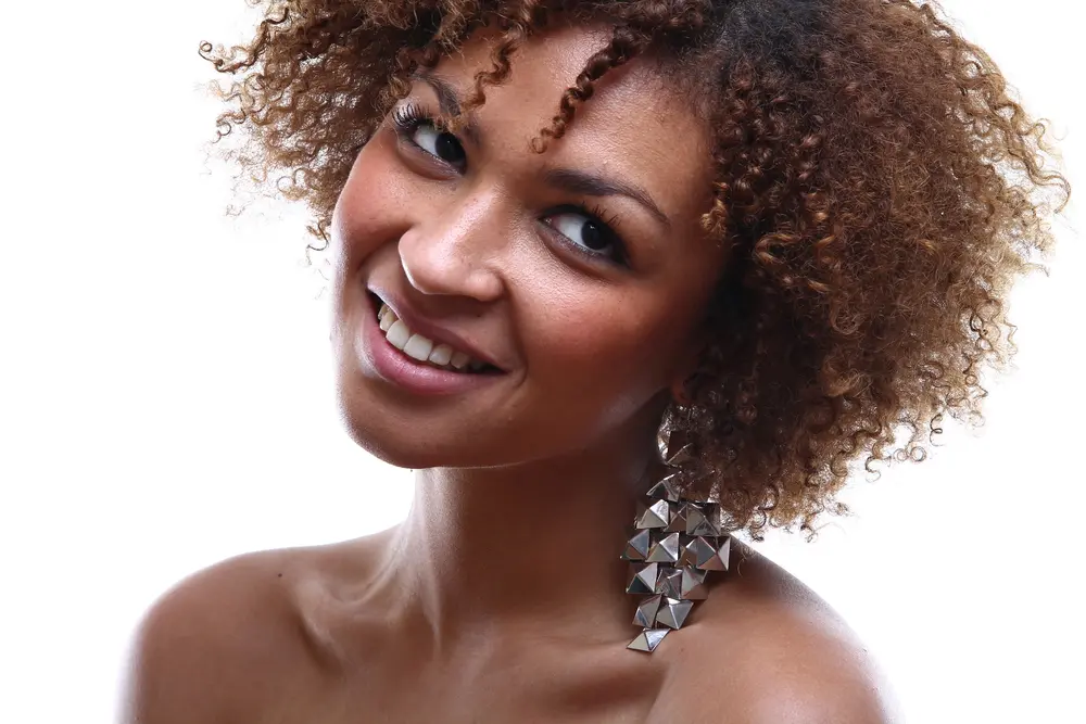 Cute black girl wearing a silver hair clips with type 3c curly hair.