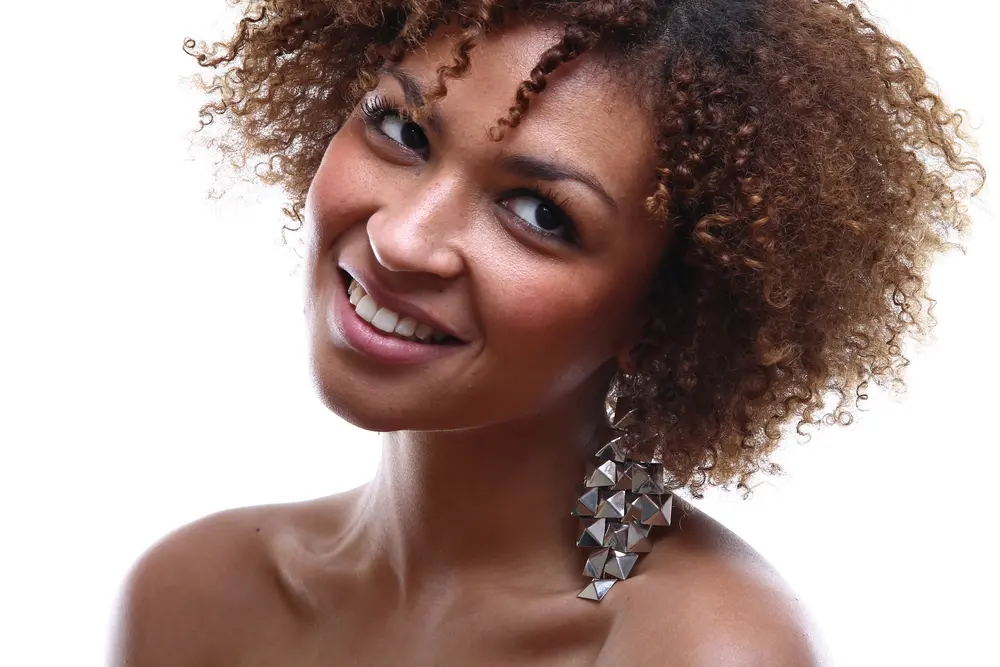 The Best Types of Hair Clips for Women with Naturally Curly Hair (and Other Hair Types) 3 Cute black girl wearing a silver hair clips with type 3c curly hair.