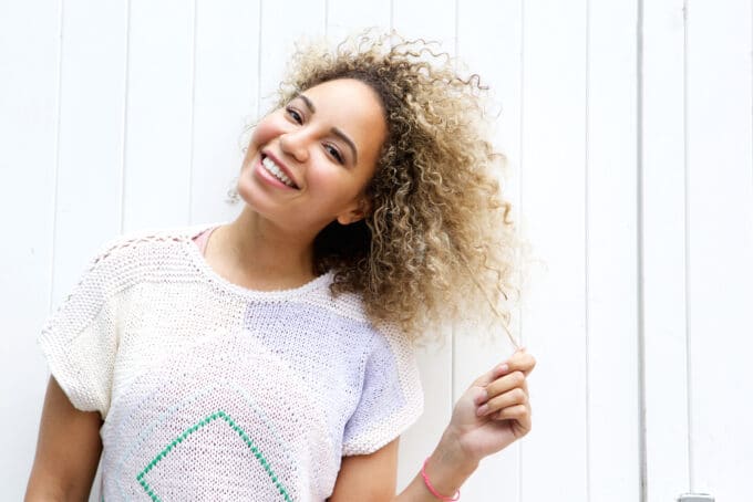 Cute African American girl brown and black curly hair styled with mixed hair dye