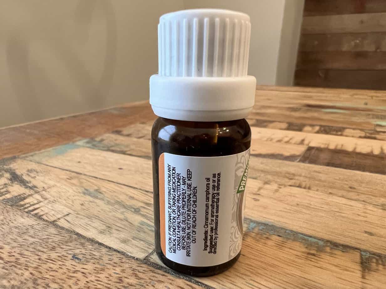 The ingredients list includes 100% pure Cinnamomum camphora oil. The suggested use is for aromatherapy use or as directed by a professional essential oil reference.
