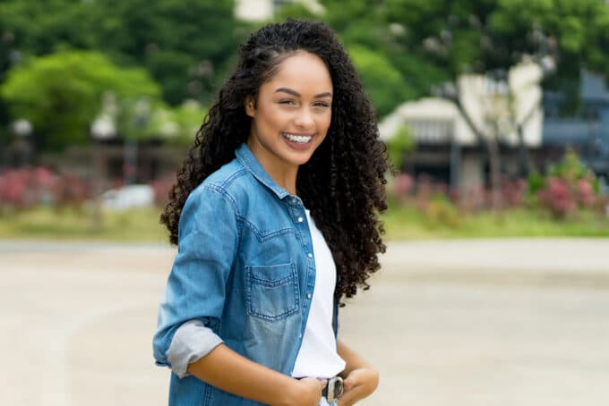 African American female with naturally curly type 3c hair.