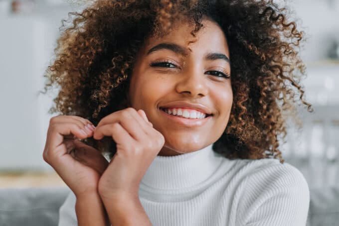 young black girl learning how to detangle natural hair with aloe vera