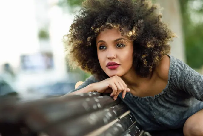 How To Dilute Hair Dye With Shampoo, Conditioner, Water, Pastel Colors, and More 7 Black women sitting on bench in Oak Mountain State Park watching her friend fish.