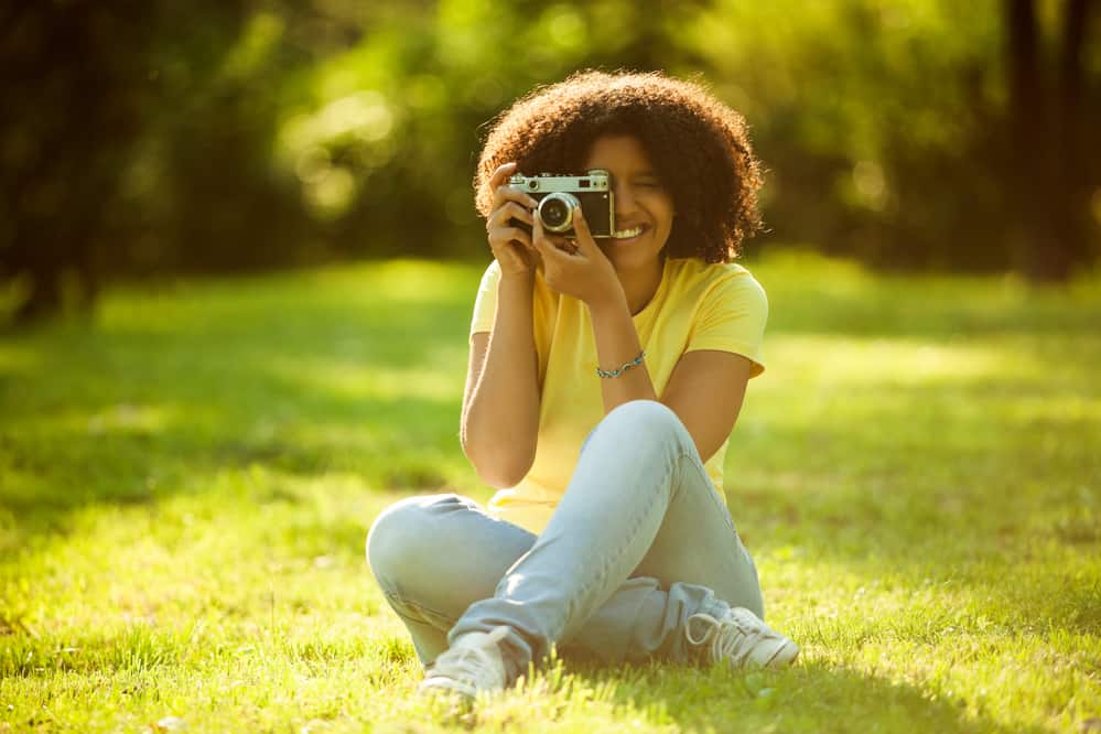 An African American woman with brittle hair cuticles styled with a combination of essentials and leave-in conditioners.