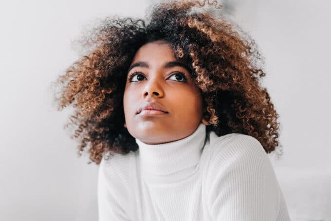 Black women with type 4b curly hair that been dyed brown and black after being detangled.