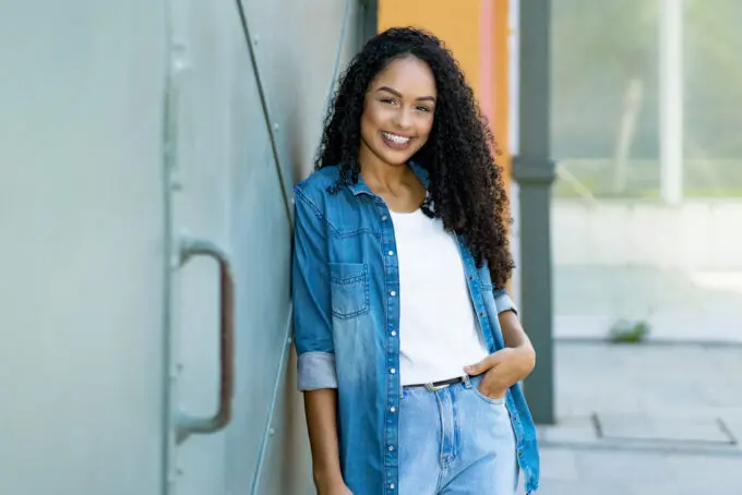 How To Get Bonding Glue Out of Hair Extensions at Home 3 African American women wearing a blue jean outfit and a white t-shirt with type 3c natural hair.