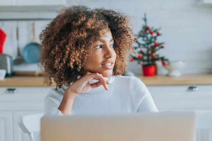 How to Detangle Natural Hair Without Breakage: DIY Detangling 9 African American female looking into the distance, wondering when the right time is to detangle curly hair.