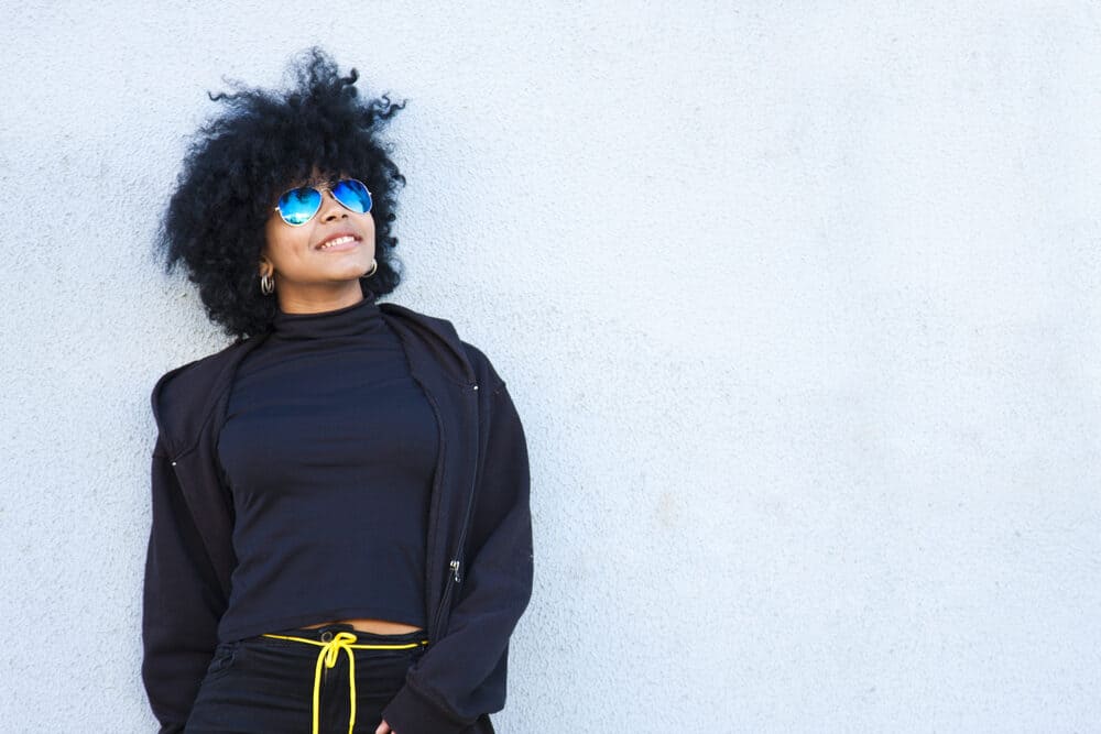 African American women wearing a black jogging suit with a yellow rope belt.