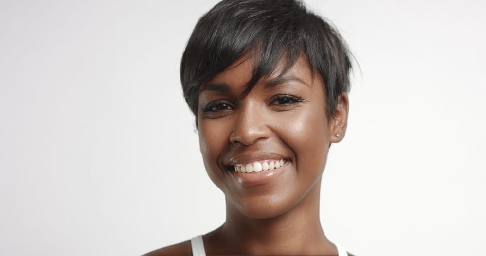 African American female with a silk wrap hairstyle on natural hair with a great smile.