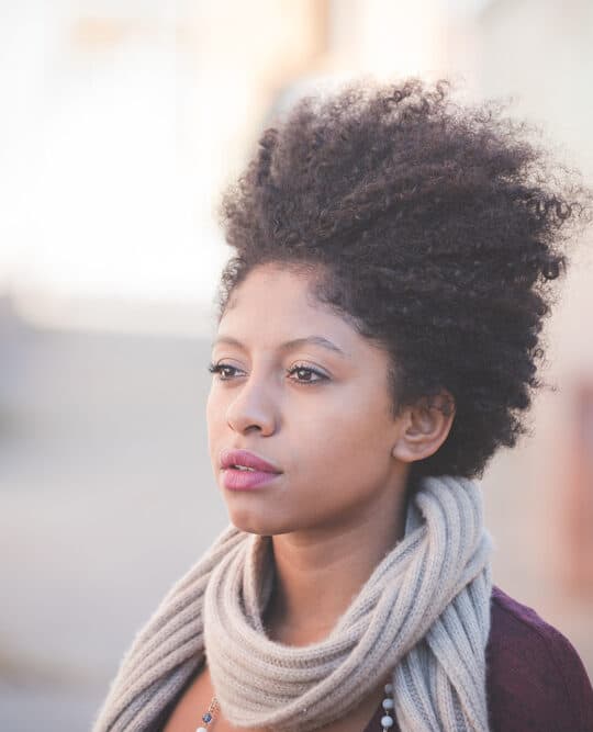 Cute black girl with healthy hair that's considering taking MSM powder for natural hair growth