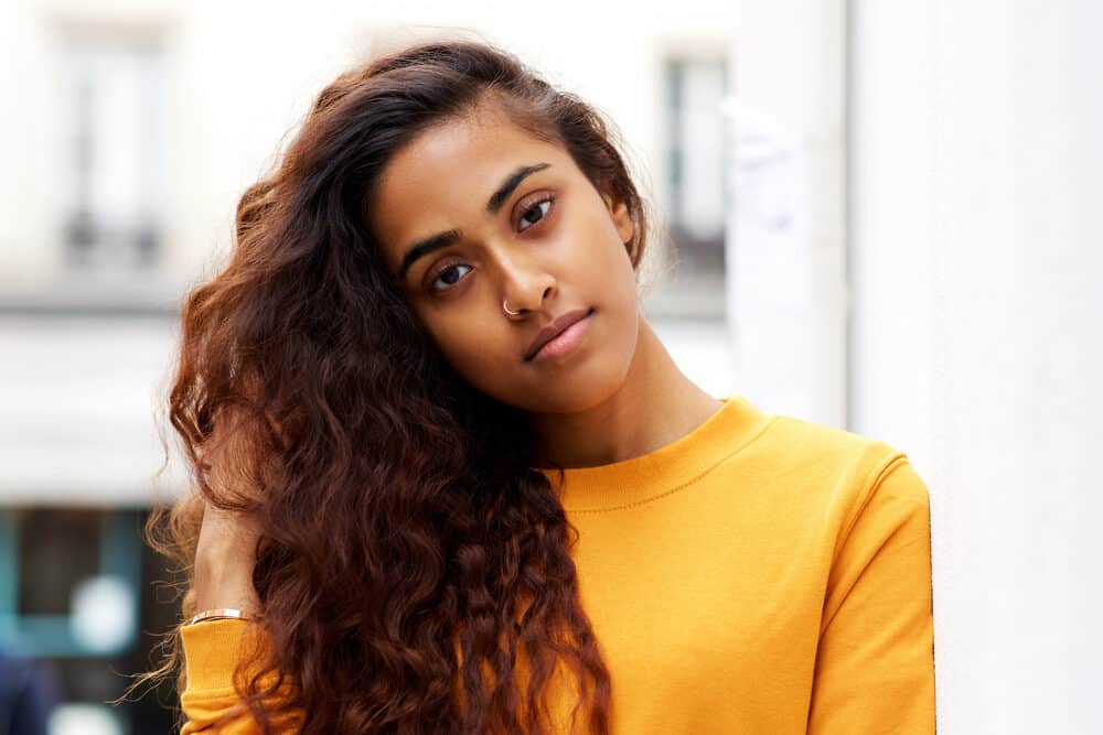 A beautiful dark-skin female leaving a hair appointment with freshly washed hair during a particularly hectic week.