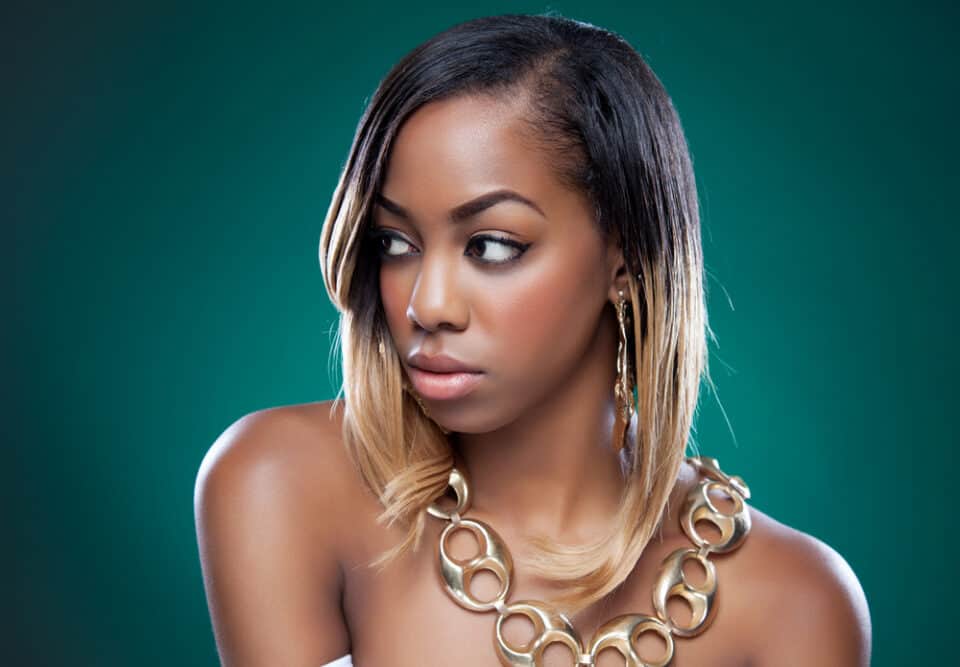 Cute black girl wearing a gold necklace with black and blonde highlights - a gorgeous color for your caramel brown skin.