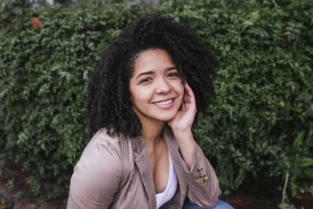 Hispanic girl with limp hair ready for a date after using chile shampoo for hair growth and moisture on her 3c curly hair