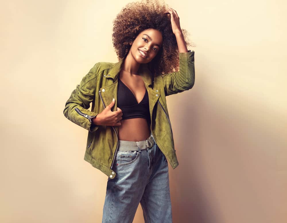 Cute black female showing off brown curls and pink lipstick.