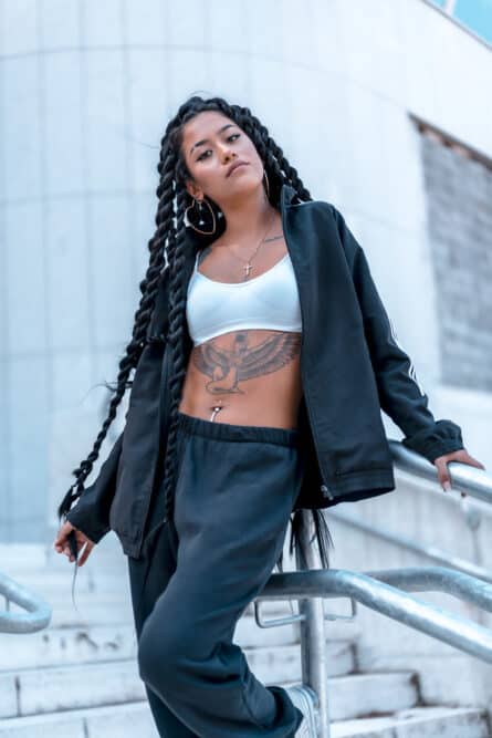 Mixed race girl with a type 2a curl pattern wearing Brazilian virgin hairpieces in long braids