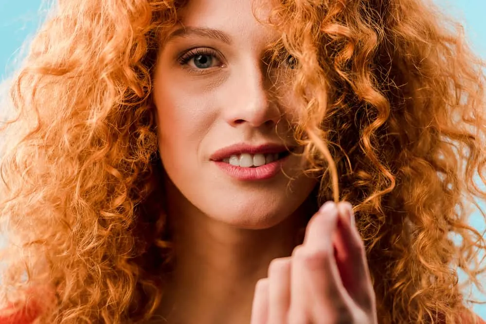 Close-up of white female with 2c wavy hair with redhead gene.