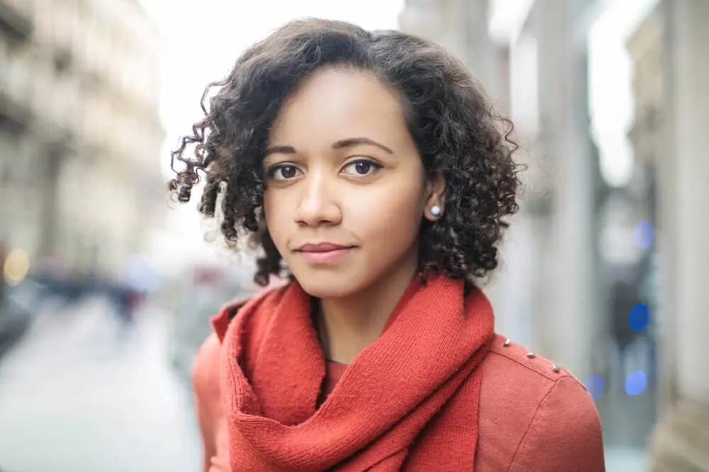 African American female wearing a red neck scarf with unwashed 3c hair strands